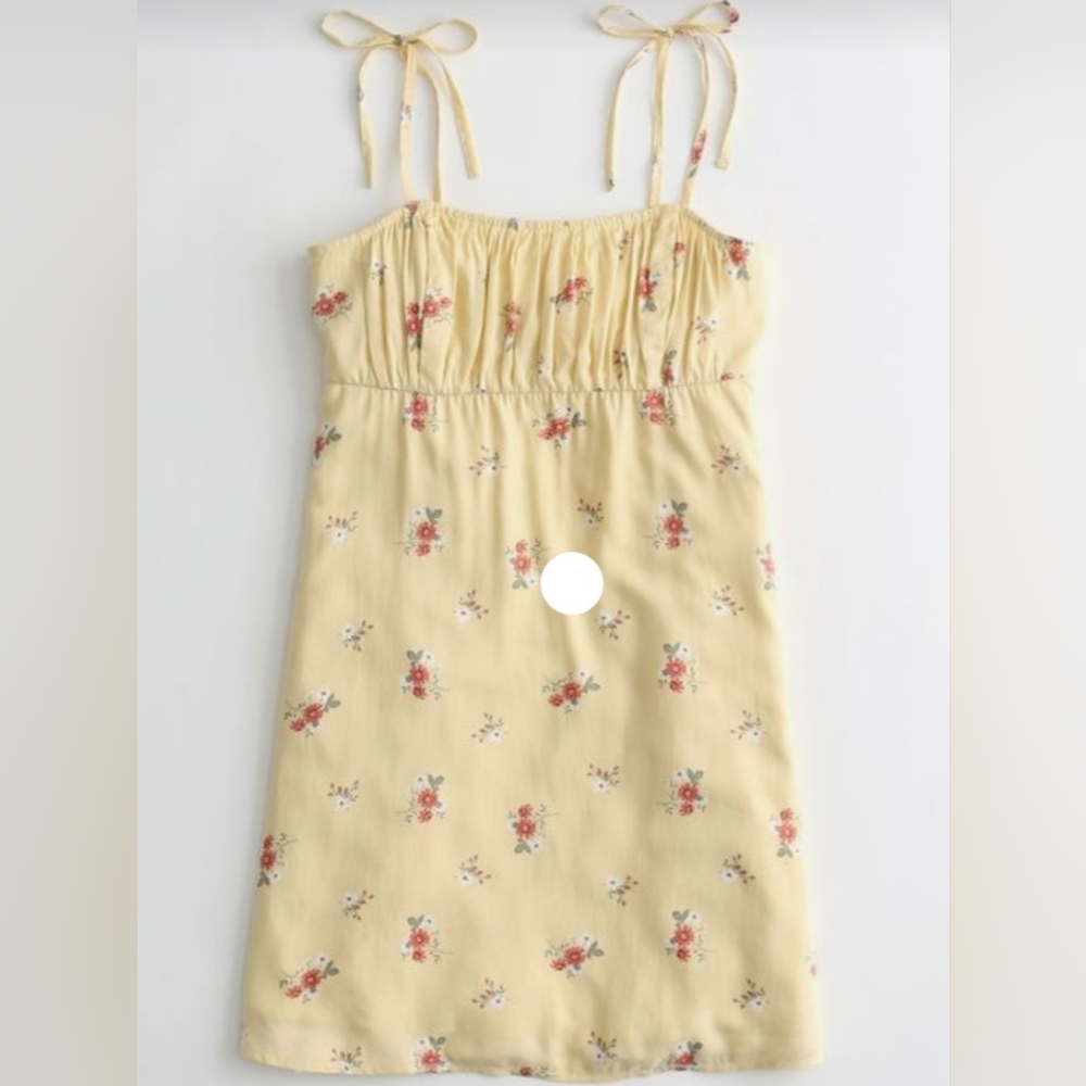 Cute and comfortable mini yellow dress with adjustable straps.